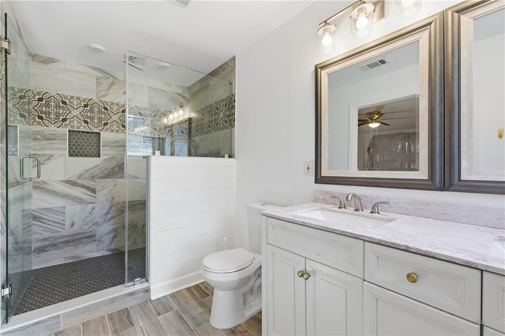 1532 Alverado Way Decatur, GA 30032 - Photo 24 of 41 a bathroom with a granite countertop sink toilet and shower