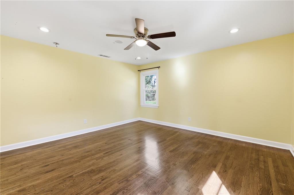 1532 Alverado Way Decatur, GA 30032 - Photo 29 of 41 a view of an empty room with wooden floor and a ceiling fan