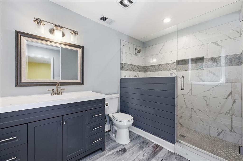 1532 Alverado Way Decatur, GA 30032 - Photo 30 of 41 a bathroom with a sink a toilet and shower