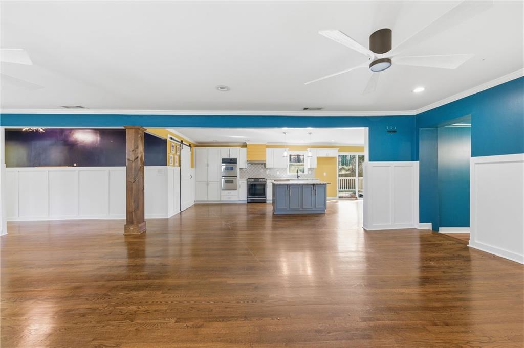 1532 Alverado Way Decatur, GA 30032 - Photo 3 of 41 a view of an empty room with wooden floor and a ceiling fan