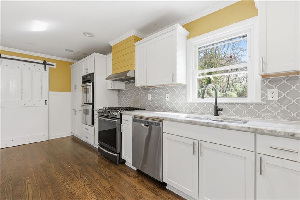 1532 Alverado Way Decatur, GA 30032 - Photo 10 of 41 a kitchen with a sink cabinets stainless steel appliances and a window