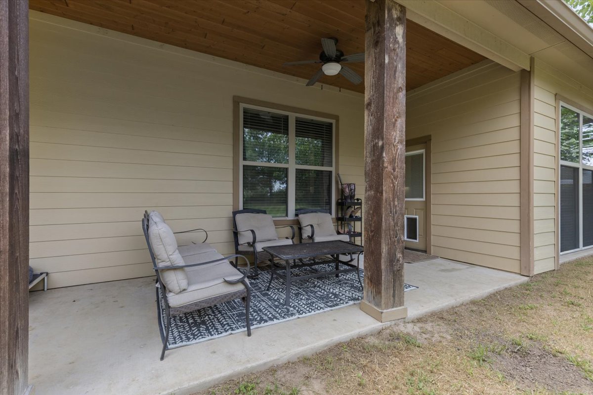 145 Cardinal Loop Paige, TX 78659 - Photo 33 of 40 A spacious covered patio invites relaxation and enjoyment of the outdoors.
