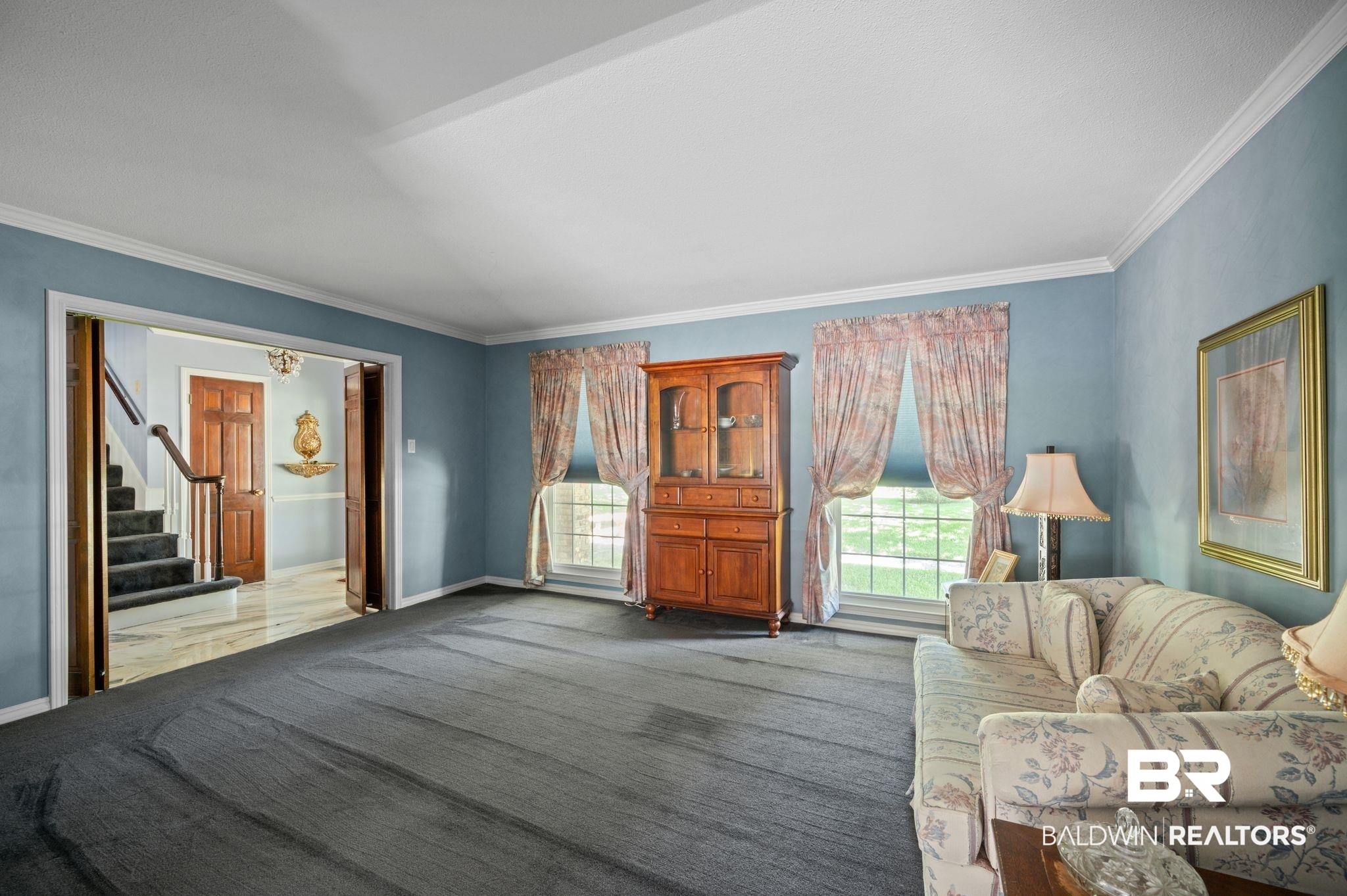 950 Walter Smith Road Mobile, AL 36695 - Photo 9 of 51 Carpeted living area with ornamental molding, stairs, and baseboards