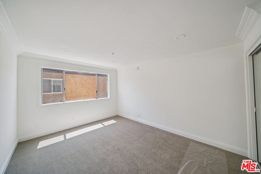 1508 Greenfield Avenue, Unit 206 Los Angeles, CA 90025 - Photo 17 of 31 an empty room with a window