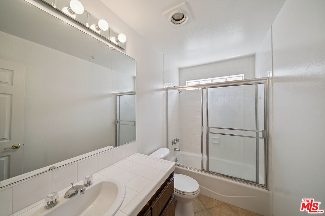 1508 Greenfield Avenue, Unit 206 Los Angeles, CA 90025 - Photo 21 of 31 a bathroom with a sink toilet and shower