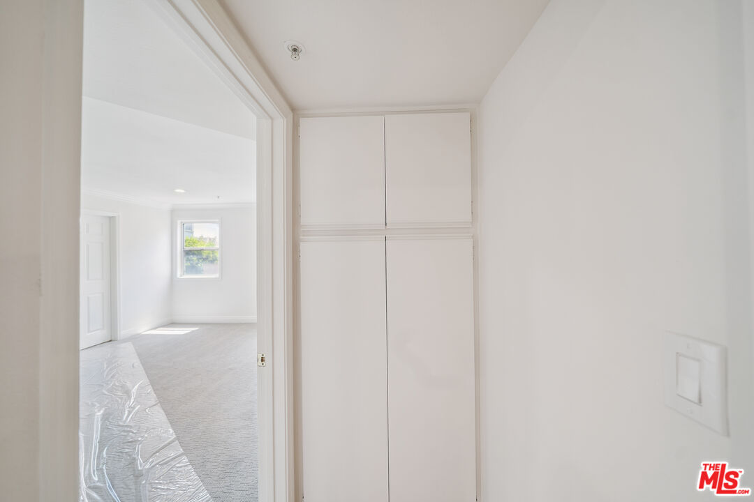 1508 Greenfield Avenue, Unit 206 Los Angeles, CA 90025 - Photo 22 of 31 a view of a hallway with white walls