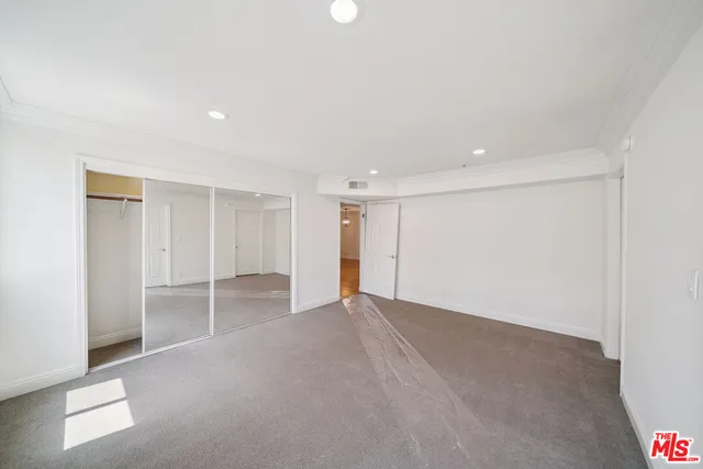 a spacious bathroom with a shower sink and mirror