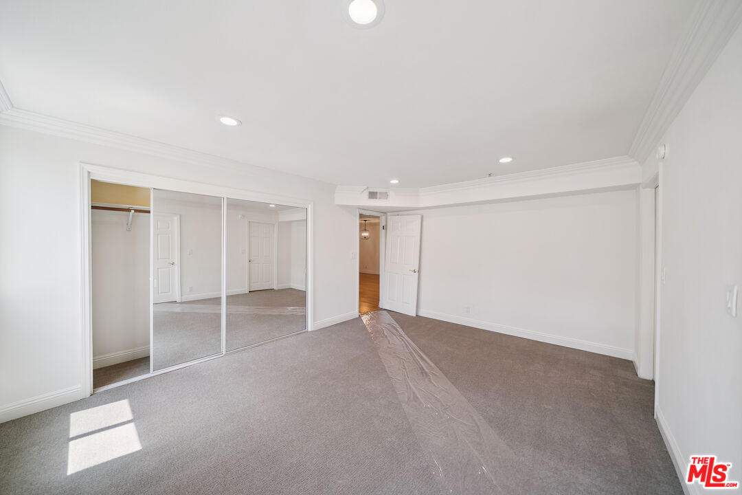 1508 Greenfield Avenue, Unit 206 Los Angeles, CA 90025 - Photo 24 of 31 a view of an empty room with wooden floor