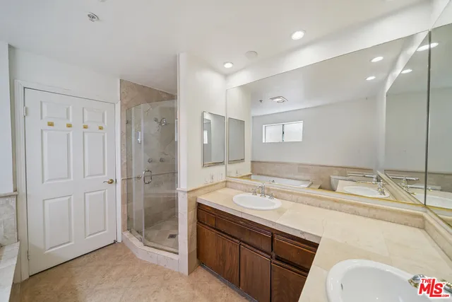 a bathroom with a tub sink and mirror