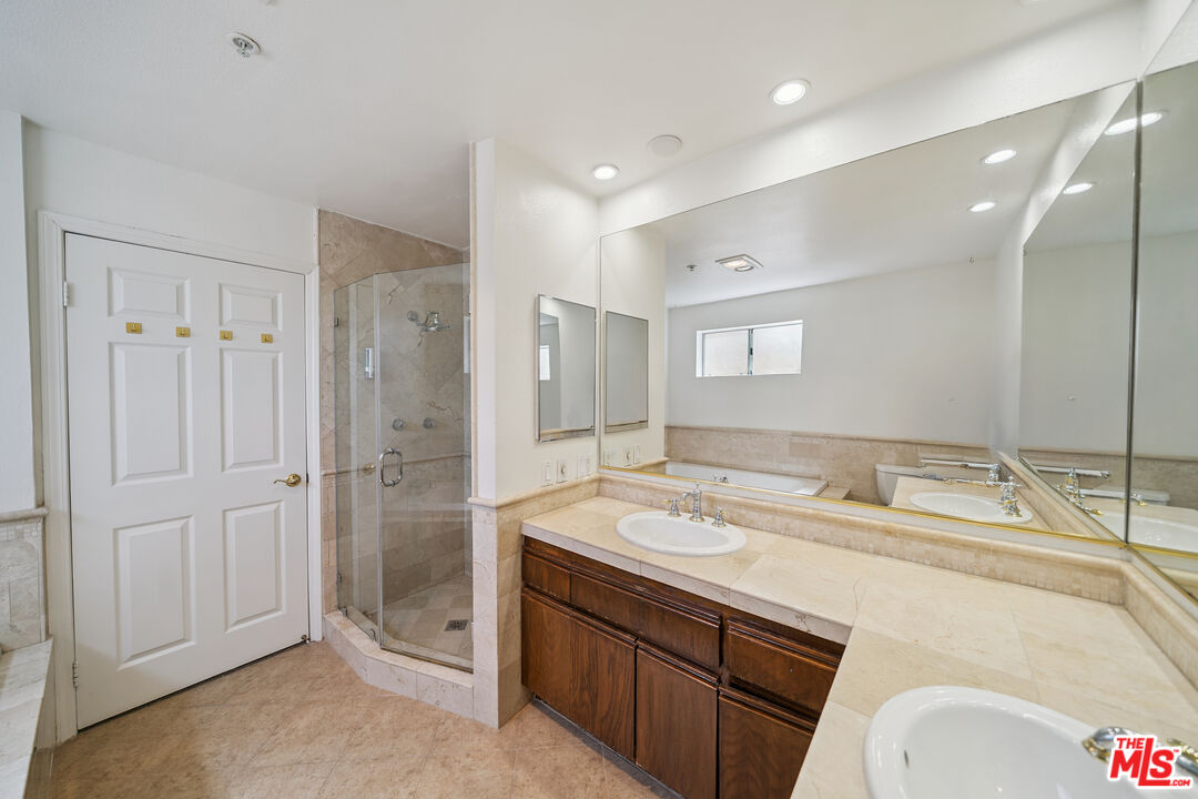 1508 Greenfield Avenue, Unit 206 Los Angeles, CA 90025 - Photo 25 of 31 a spacious bathroom with a shower sink and mirror