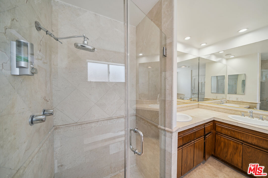 1508 Greenfield Avenue, Unit 206 Los Angeles, CA 90025 - Photo 27 of 31 a bathroom with a shower sink and mirror