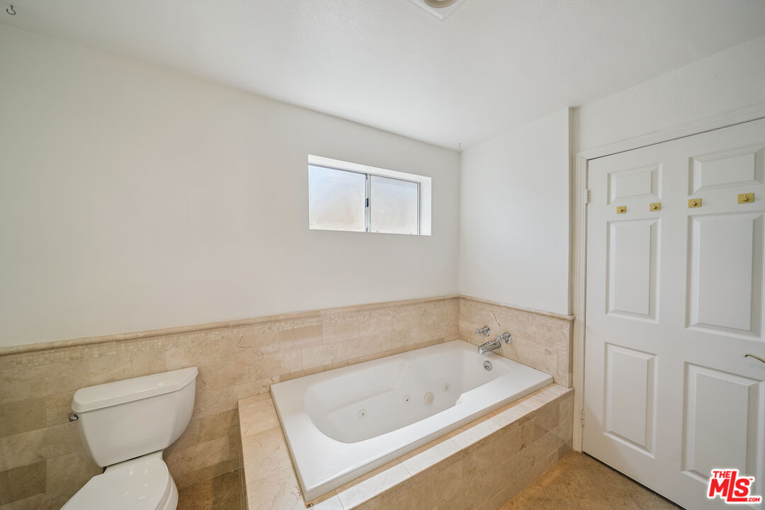 1508 Greenfield Avenue, Unit 206 Los Angeles, CA 90025 - Photo 28 of 31 a bathroom with a tub a toilet and a sink