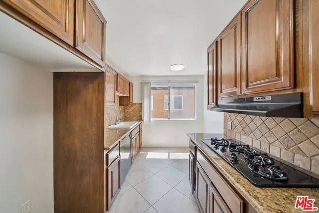 a kitchen with stainless steel appliances granite countertop a stove and a refrigerator
