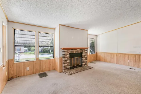 an empty room with furniture and a fireplace