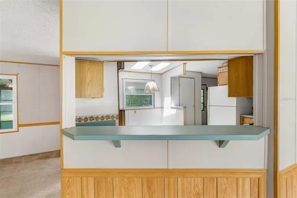 a view of kitchen with granite countertop cabinets and a wooden floor