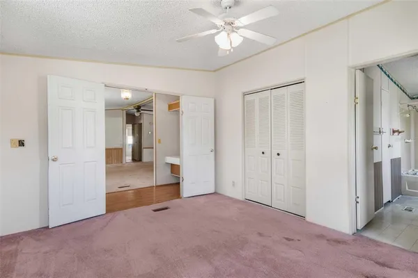 an empty room with fan and entrance