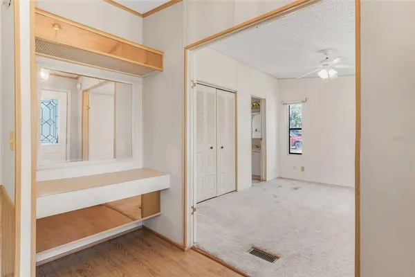 an empty room with windows and closet