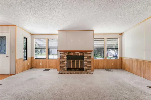 an empty room with furniture and a fireplace