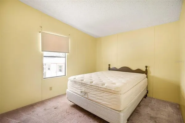 a view of a bedroom with wooden floor