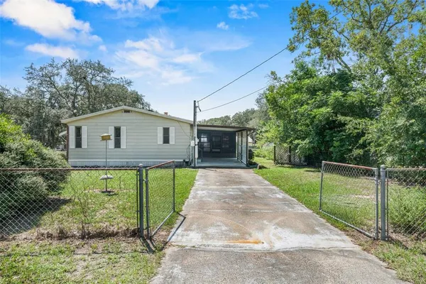a view of a house with a backyard