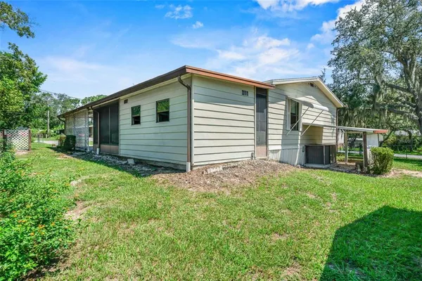 a view of a house with a yard and plants