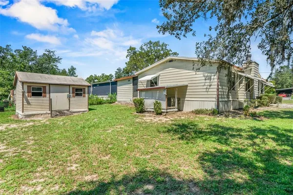 a view of a house with a yard