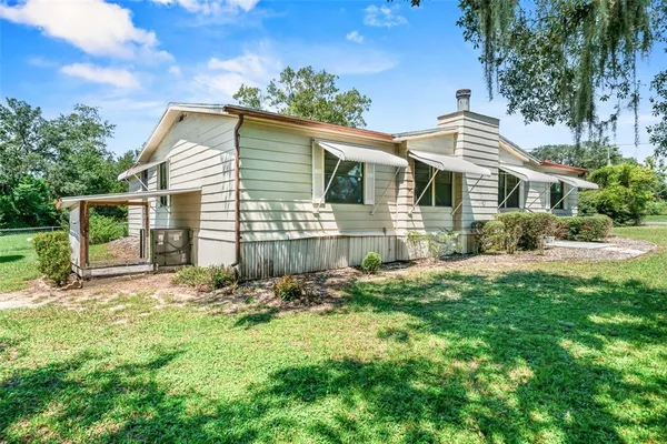 a view of house with outdoor space and garden