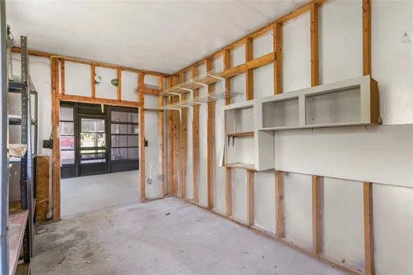 a view of empty room with cabinet and ceiling fan