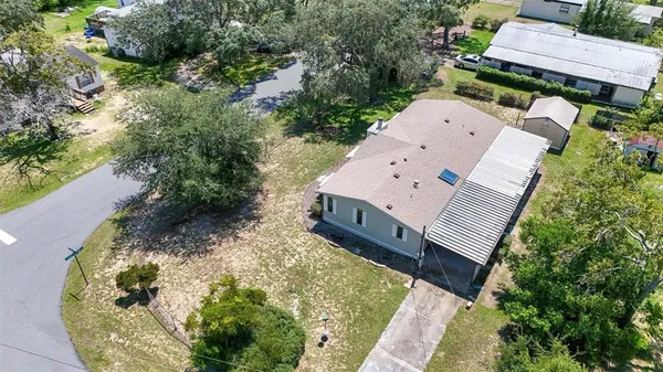 an aerial view of a house with yard porch and furniture