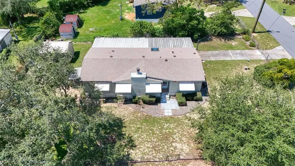 an aerial view of a house with yard and outdoor space