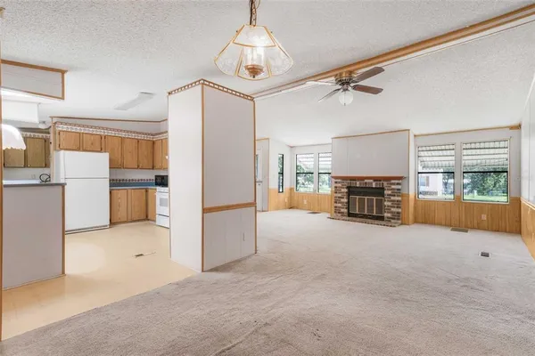 a view of livingroom with furniture and kitchen view