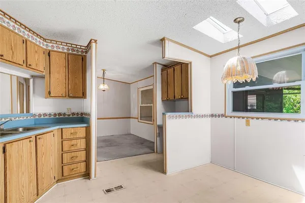 a bathroom with a granite countertop sink a mirror and shower