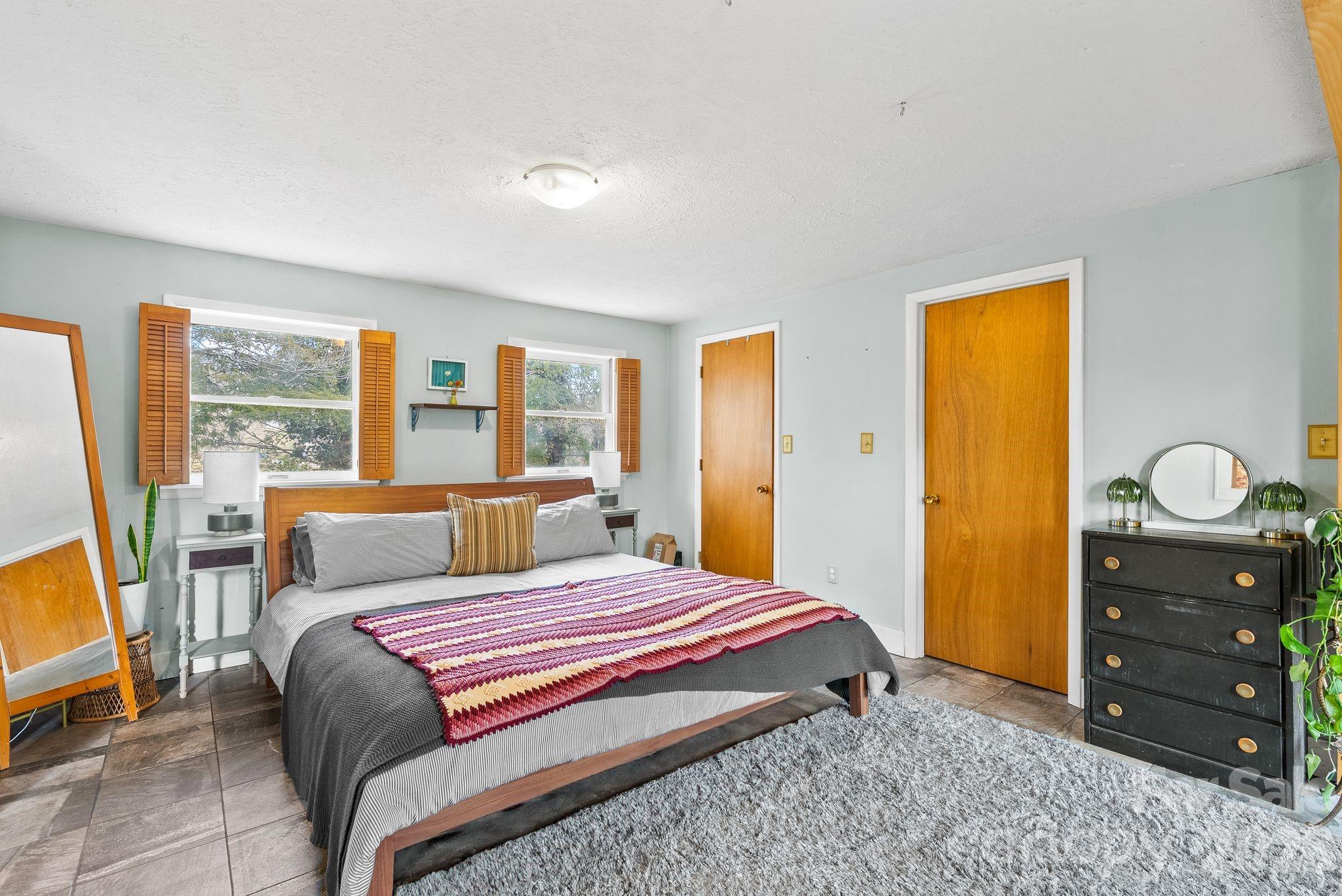271 Pisgah View Road Asheville, NC 28806 - Photo 14 of 40 a bedroom with a bed and wooden floor