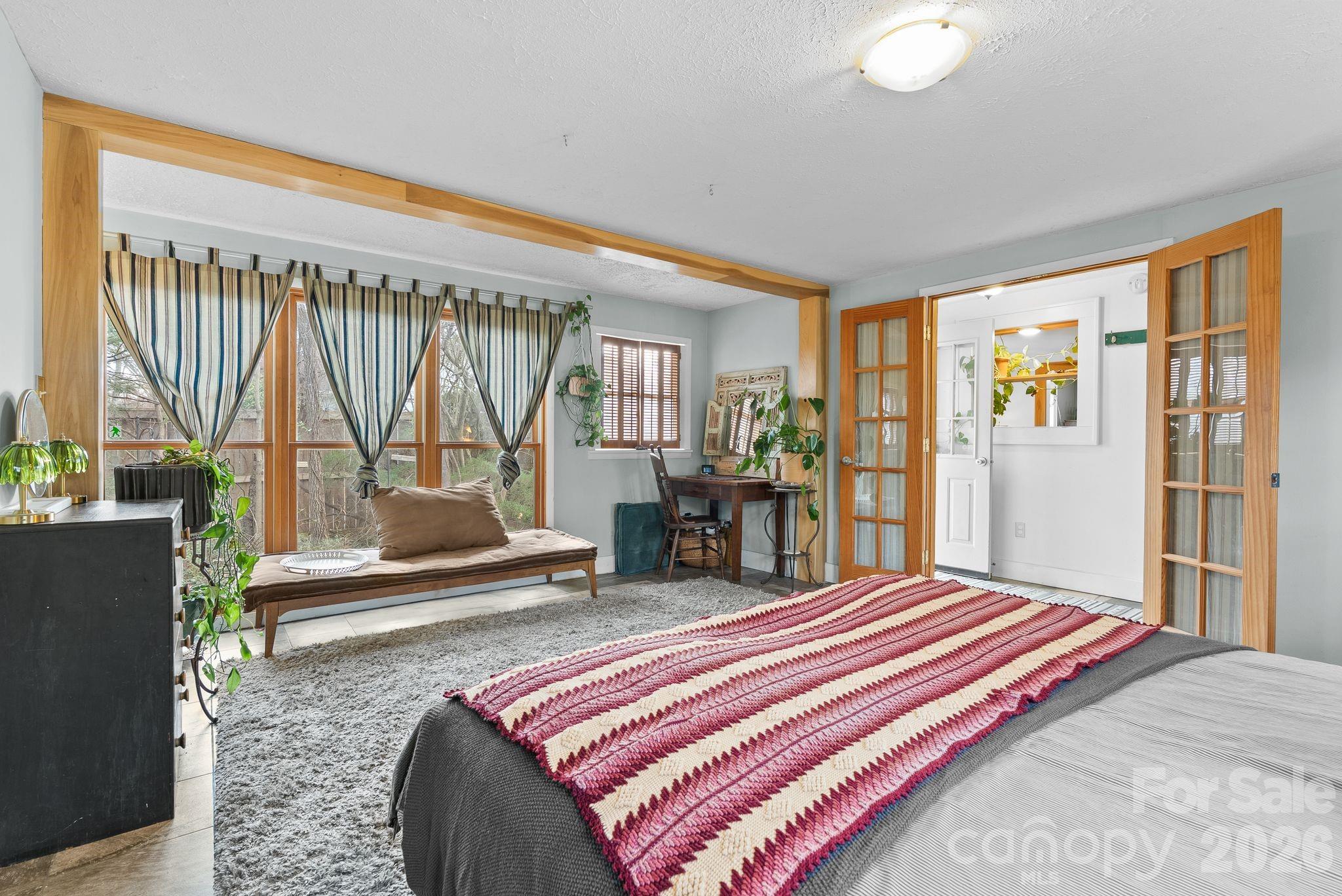 271 Pisgah View Road Asheville, NC 28806 - Photo 16 of 40 a bedroom with a bed and large windows