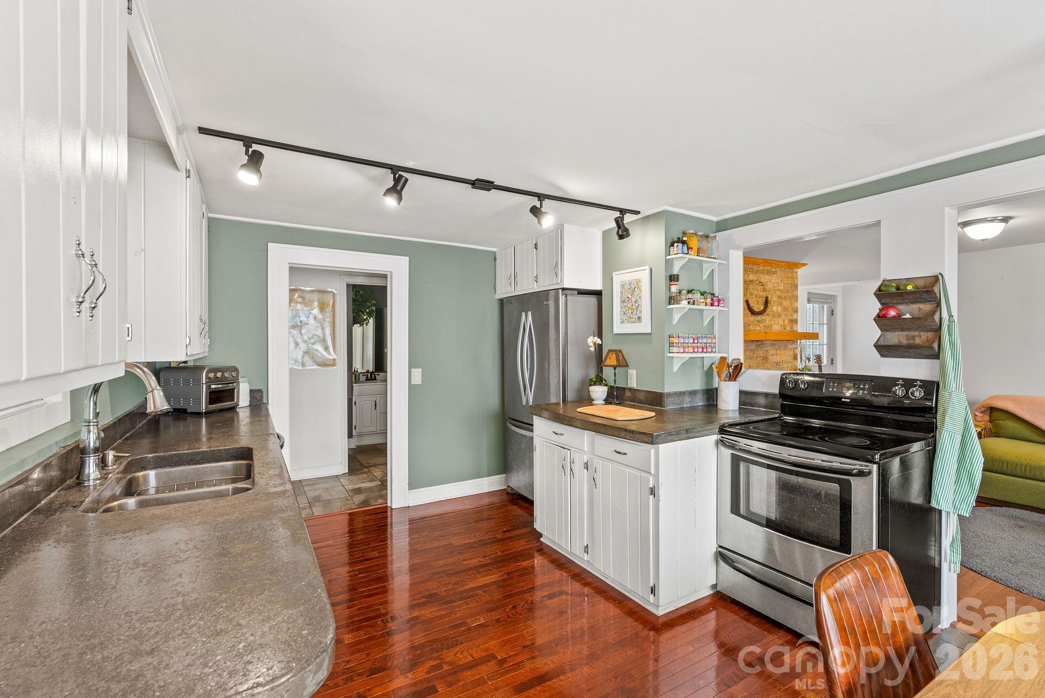 271 Pisgah View Road Asheville, NC 28806 - Photo 3 of 40 a kitchen with stainless steel appliances granite countertop a stove and a refrigerator