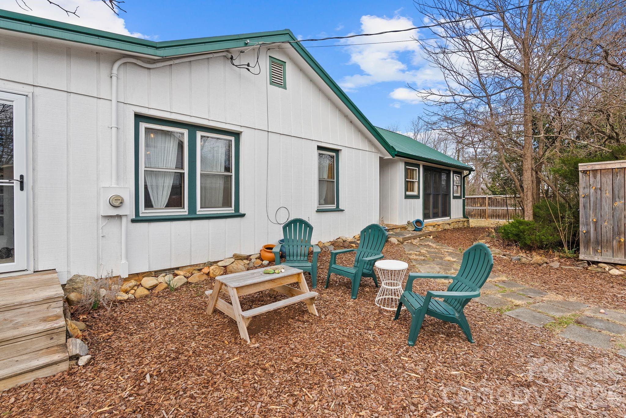 271 Pisgah View Road Asheville, NC 28806 - Photo 36 of 40 a backyard of a house with wooden floor and outdoor seating
