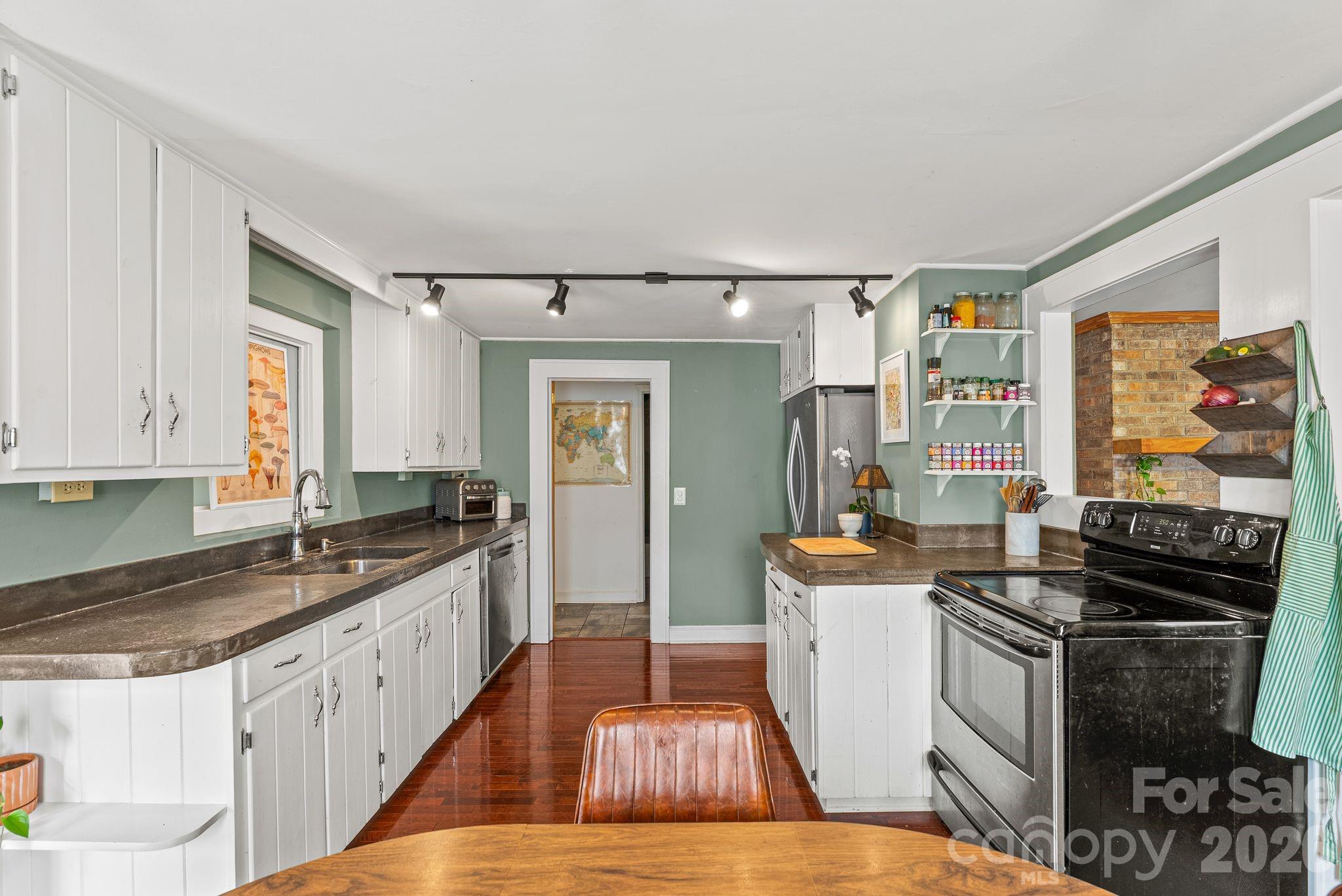 271 Pisgah View Road Asheville, NC 28806 - Photo 4 of 40 a kitchen with granite countertop a stove and cabinets
