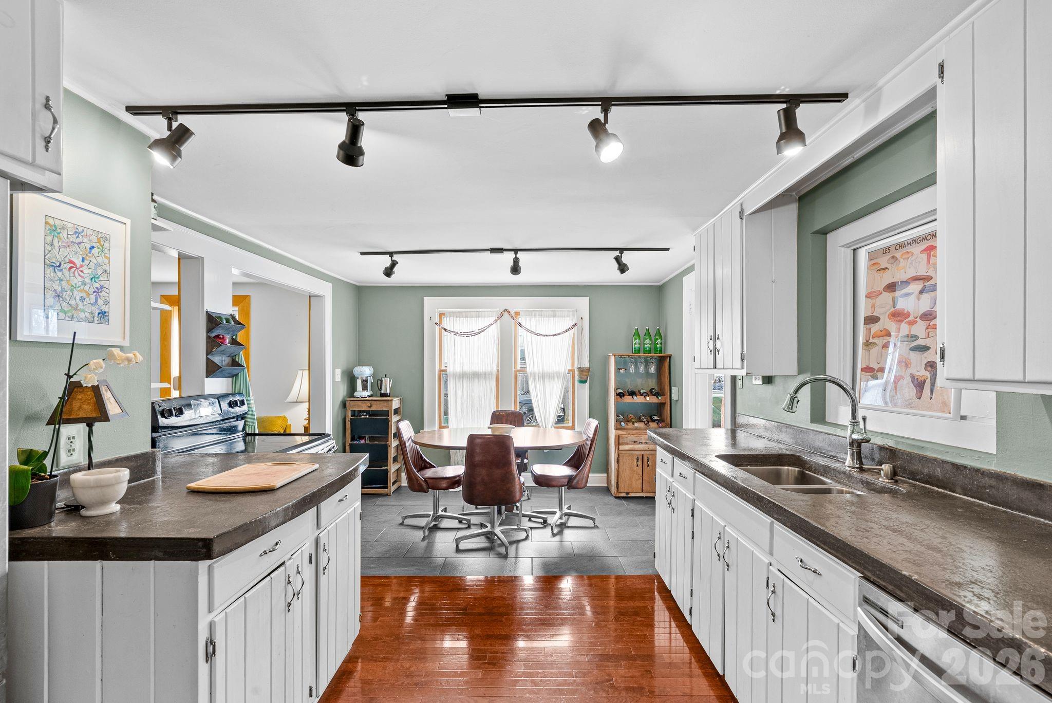 271 Pisgah View Road Asheville, NC 28806 - Photo 6 of 40 a large kitchen with kitchen island lots of counter space a sink a window and living room