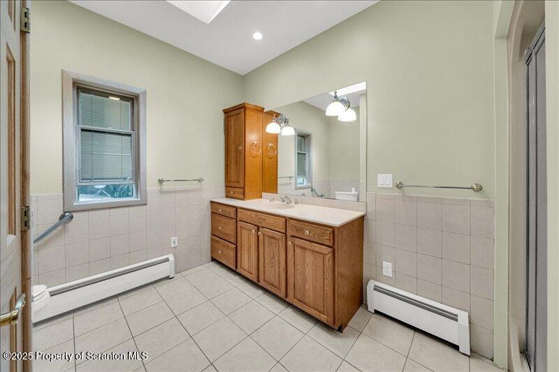 1777 Highway 2002 Nicholson, PA 18446 - Photo 27 of 52 a bathroom with a double vanity sink and a mirror