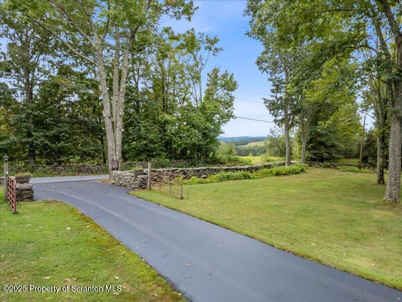 1777 Highway 2002 Nicholson, PA 18446 - Photo 5 of 52 a view of a swimming pool with a yard and large trees