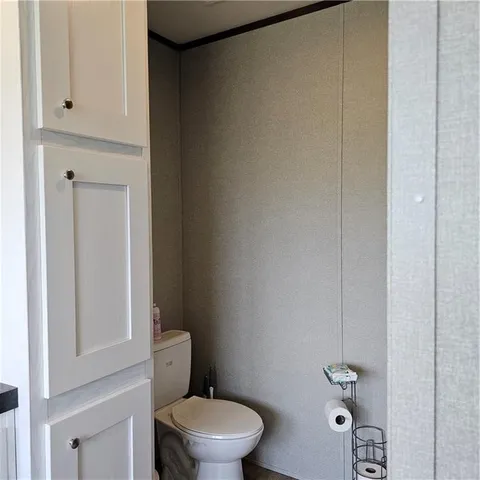 a white toilet sitting next to a bathroom sink