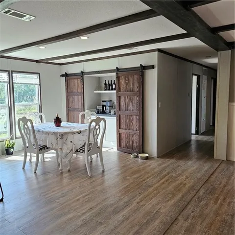 a dining room with furniture and wooden floor