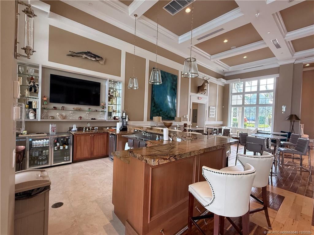 11075 West Indiantown Road, Unit 6 Jupiter, FL 33478 - Photo 14 of 14 a large living room with stainless steel appliances kitchen island granite countertop furniture and a flat screen tv