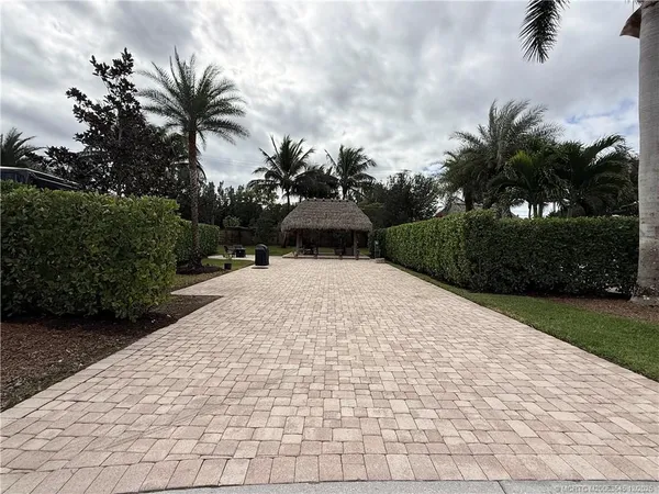 a view of a patio with table and chairs potted plants