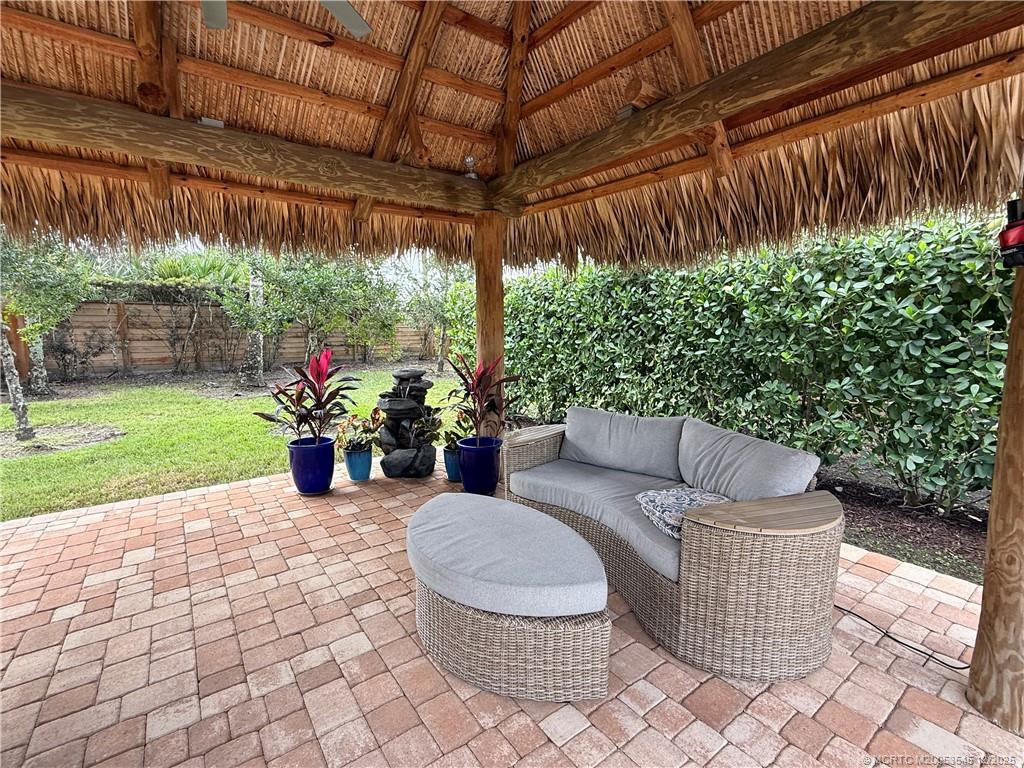 11075 West Indiantown Road, Unit 6 Jupiter, FL 33478 - Photo 9 of 14 a living room with furniture and a garden