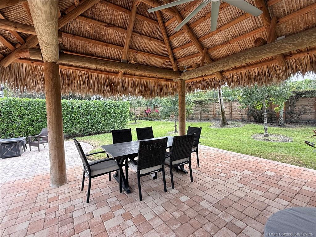 11075 West Indiantown Road, Unit 6 Jupiter, FL 33478 - Photo 10 of 14 a view of a patio with a table chairs and a backyard