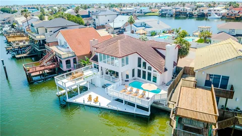 an aerial view of a house with swimming pool lawn chairs and a yard