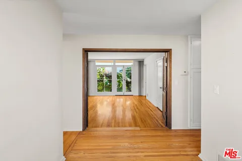 a view of a room that has a bed and a window
