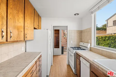 a kitchen with a stove a refrigerator and a sink
