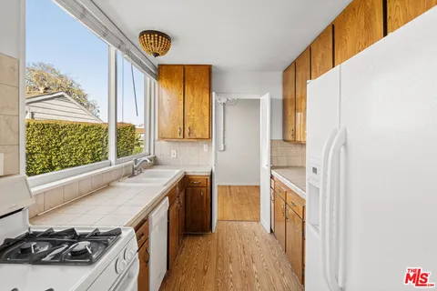 a kitchen with a sink a stove and a refrigerator